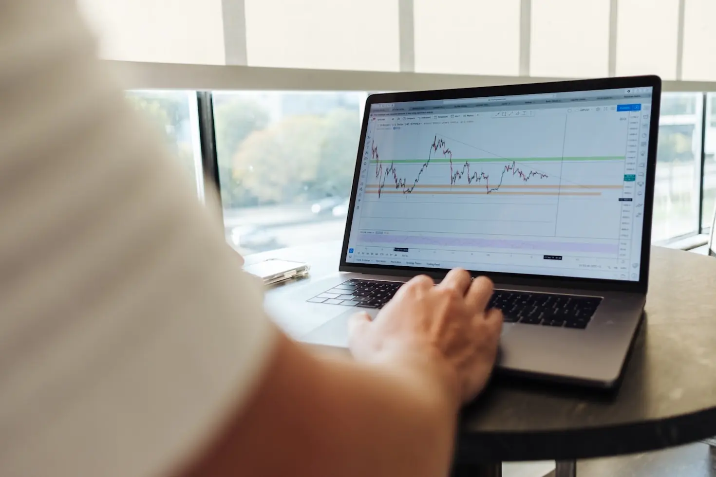 Trader reviewing a futures price chart on a laptop